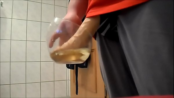 Slave with fake cock pissing