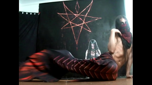 crossdresser with long hair dressed as a mermaid and doing anal fisting