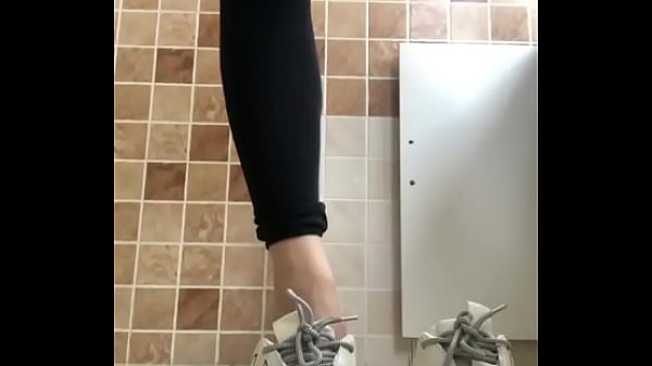 Japanese girl takes off her sneakers