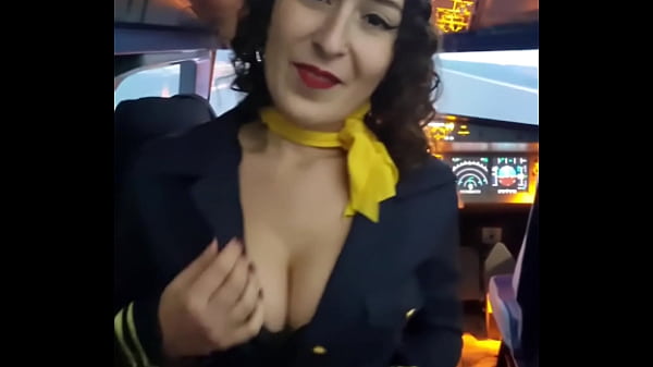 The flight attendant puts a dildo in her pussy on board